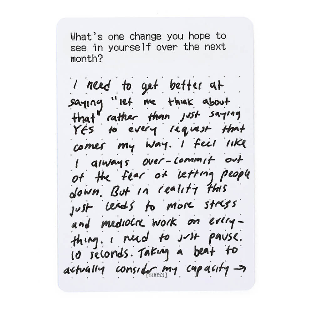 Handwritten text on a prompt card discussing over-commitment and saying yes to everyting